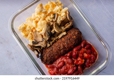 A Healthy Breakfast Containing Scrambled Eggs, Mushrooms, Cutlet And Red Beans