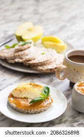 Healthy Breakfast. Crunchy Buckwheat And Rice Snack With Almond Butter And Apple, Hot Drink On The Table. 