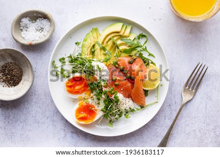 Healthy breakfast with egg, smoked salmon and avocado