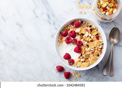 Healthy breakfast. Fresh granola, muesli with yogurt and berries on marble background. Top view. Copy space. - Shutterstock ID 1042484581