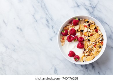 Healthy breakfast. Fresh granola, muesli with yogurt and berries on marble background. Top view. Copy space. - Powered by Shutterstock