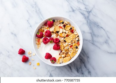 Healthy breakfast. Fresh granola, muesli with yogurt and berries on marble background. Top view. - Powered by Shutterstock