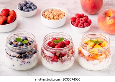 Healthy breakfast. Granola  muesli yoghurt and fruit served in glass jars.