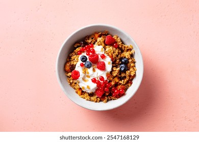 Healthy breakfast. Granola, muesli with yogurt and fresh berries. Pink background. Top view. - Powered by Shutterstock