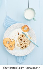 Healthy breakfast granola with yogurt, oats, dried apple slices, raisins and milk - Shutterstock ID 250188247