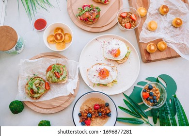 Healthy Breakfast, Morning Porridge With Fruits, Bruschettas With Avocado, Fried Eggs, Granola And Cheesecakes For Big Family