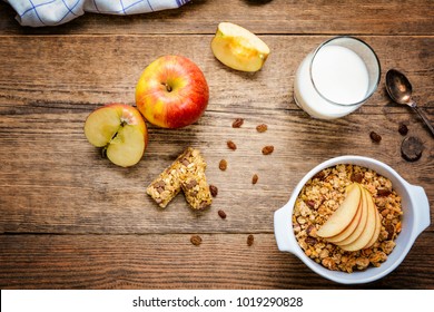 Healthy Breakfast. Muesli With Apple,raisins, Muesli Bar And Milk Top View