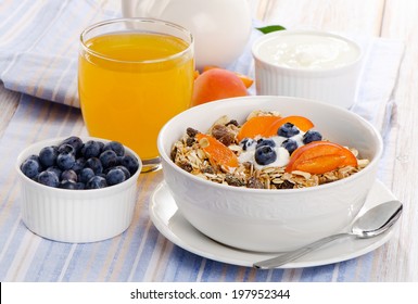 Healthy breakfast - muesli with yogurt and fresh juice . Selective focus - Powered by Shutterstock