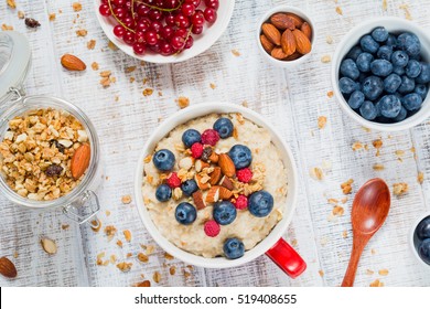 Healthy Breakfast: Oatmeal Porridge With Fresh Blueberries, Raspberries And Muesli. Overhead View