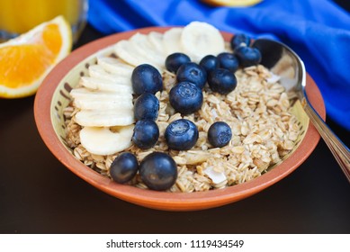 Healthy Breakfast Oatmeals Bannana Slice And Blueberry Orange Juice. Black Board. 