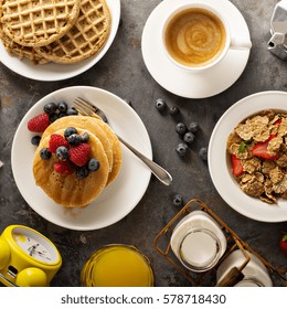 Healthy Breakfast On The Table With Cereals, Fruit, Pancakes And Waffles Overhead Shot