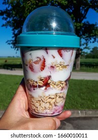 Healthy Breakfast Overnight Oats With Strawberries, Blueberries And In A Plastic Container With Beautiful Outdoor Background - Food Prep And Meal Prep Concept