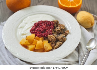 Healthy Breakfast Parfait Of Granola, Greek Yogurt, Apricot And Raspberry Chia Jam In A Bowl. Fruits In The Back