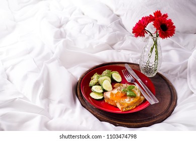 Healthy breakfast served to bed with flowers