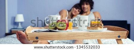 Similar – Image, Stock Photo Healthy breakfast on tray and couple lying in background