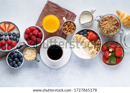 Healthy breakfast set on grey background. The concept of delicious and healthy food. Top view, copy space.