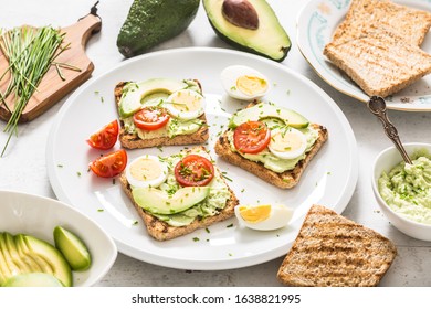 Healthy Breakfast From Toasts With Avocado Spread Guacamole Egg Tomato And Chives.