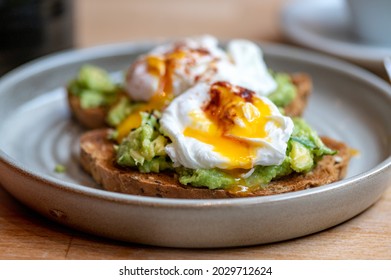 Healthy Breakfast with Wholemeal Bread Toast and Poached Egg with mashed Avocado