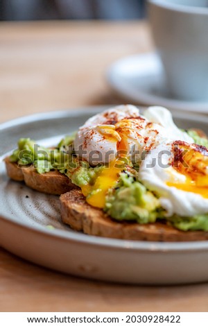 Healthy Breakfast with Wholemeal Bread Toast and Poached Egg with mashed Avocado