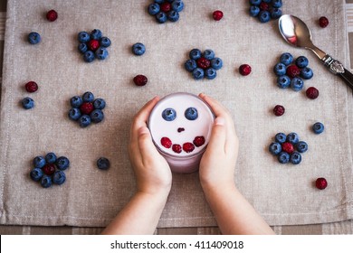 Healthy breakfast of yogurt and berries. Child creative breakfast. Top view, flat lay