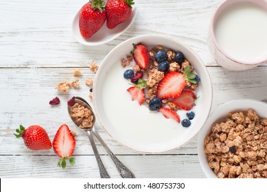 Healthy breakfast. Yogurt with granola, strawberry and blueberry. Top view with copy space - Powered by Shutterstock