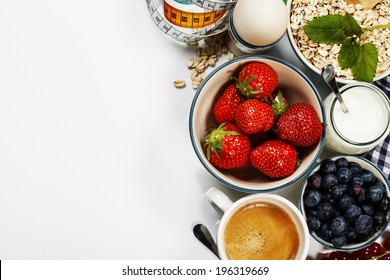 Healthy breakfast - yogurt, muesli, berries and measurement tape - health and diet concept - Shutterstock ID 196319669