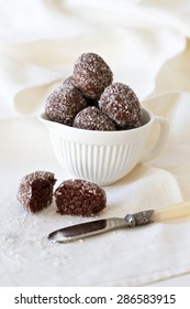 Healthy Cacao Protein Balls Made With Dates And Coconut In A White Bowl