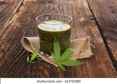 Healthy cannabis smoothie on wooden background. Natural supplement, detox and healthy living. 