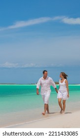 Healthy Caucasian Couple In White Clothes Carefree Outdoors By The Ocean On Tropical Luxury Caribbean Travel Resort 