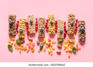Healthy Cereal Bars, Berries And Nuts On Color Background