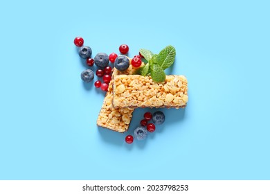 Healthy Cereal Bars And Berries On Color Background