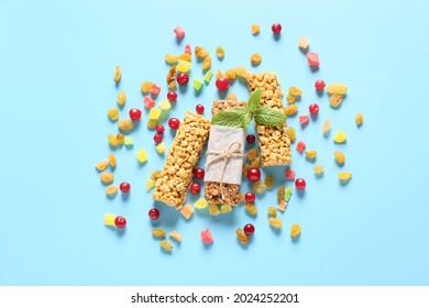Healthy Cereal Bars And Candied Fruits On Color Background