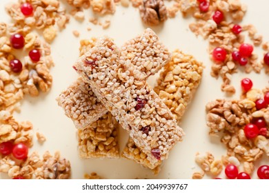 Healthy Cereal Bars And Cranberries On Color Background