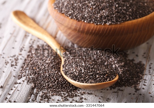 Healthy Chia seeds in a wooden spoon on the\
table close-up.\
horizontal\
