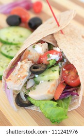 Healthy Chicken Wrap Greek Style With Fresh Vegetables, Black Olives, Feta Cheese And Herbs