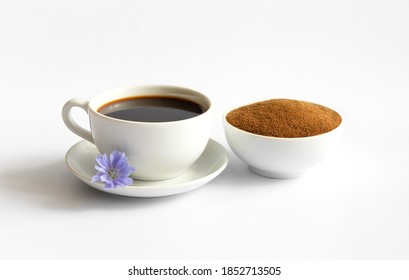 Healthy chicory drink, powder and blue flower isolated on white background. Cichorium intybus. Decaffeinated coffee.