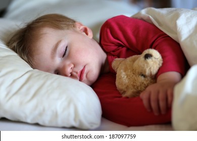 Healthy Child, Sweetest Blonde Toddler Girl Sleeping In Bed Holding Her Teddy Bear