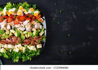 Healthy Cobb Salad With Chicken, Avocado, Bacon, Tomato, Cheese And Eggs. American Food. Top View. Flat Lay, Overhead
