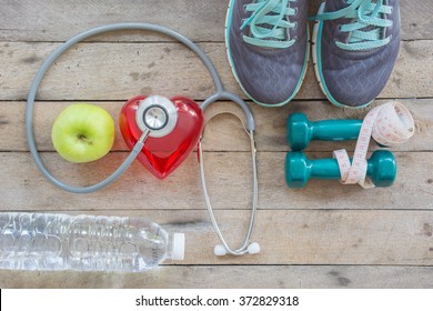 Healthy Concept , Diet Plan With Sport Shoes And Bottle Of Water And Dumbell On Wooden Background