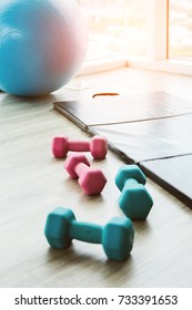 Healthy Concept With Fitness Center Dumbell Rack And Yoga Ball With Exercise Mat On Wooden Floor With Background Of Blue Sky