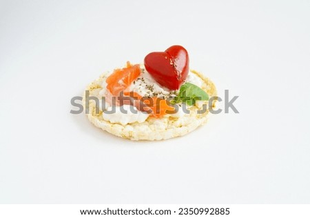 Healthy corn cake with cream cheese, salmon and Cherry tomatoe shaped of heart on the white background