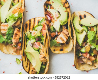 Healthy corn tortillas with grilled chicken fillet, avocado, fresh salsa, limes over light grey marble table background, top view. Healthy food, gluten-free, allergy-friendly, weight loss concept - Powered by Shutterstock