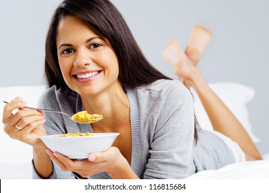 healthy cornflakes breakfast in bed woman eating and happy - Shutterstock ID 116815684
