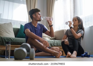 Healthy Couple Drinking Water, Take A Break After Workout At Home. Healthy Lifestyle, Yoga, Pilates, Exercising Concept.