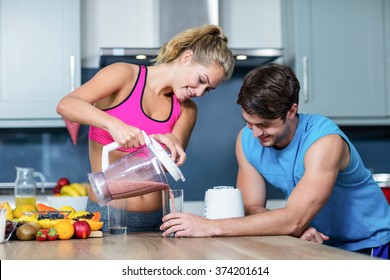 Healthy Couple Preparing A Smoothie In The Kitchen