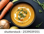 a healthy curcuma cream soup with carrots, onions, and potatoes