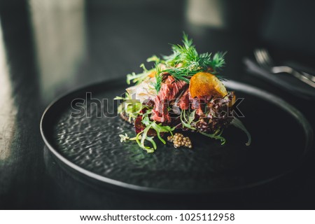 Healthy and delicious beef sandwich on dark table at restaurant, chef making food 