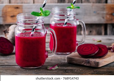 healthy detox beet smoothie with chia seeds in a mason jar on a wooden background