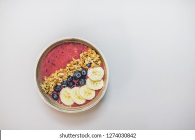 Healthy Detox Breakfast Acai Smootihie Bowl With Fruit Topping For Healthy Lifestyle. Top View On White Table