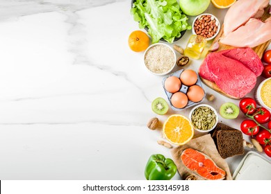 Healthy diet food. Various low fodmap ingredients selection - meat, vegetables, berry, fruit, grains, Trendy healthy lifestyle concept. On white marble background copy space top view - Powered by Shutterstock